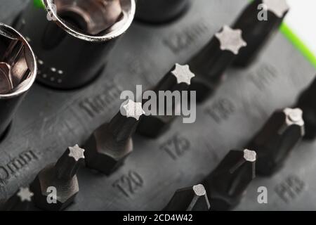 Tool box with attachments and bits of different shapes and sizes close-up. Stock Photo