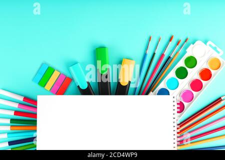 A set of school supplies for learning and creative development on a cyanide background. Stock Photo