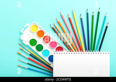 A set of school supplies for learning and creative development on a cyanide background. Stock Photo