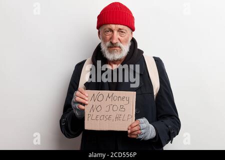 Homeless man holding sign, request for help, seeking help posing at ...