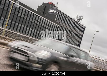 A Mini passes the BMW Mini Plant by the Oxford ring road today. Hundreds of redundancies have been confirmed there today.  The plant only resumed production recently after lockdown was eased. Credit: Martin Anderson Stock Photo