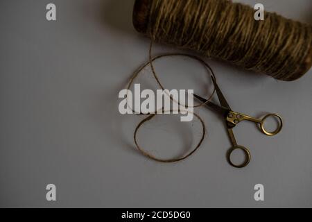 antique wooden spool and scissors on white background Stock Photo