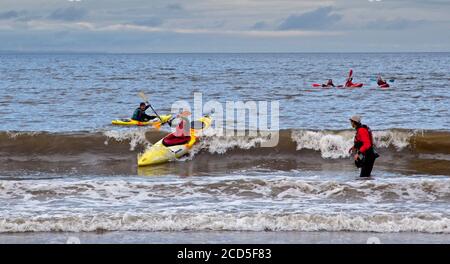 Portobello, Edinburgh, Scotland, UK. 26 August 2020. Dry evening and temperature of 14 degrees after a few days of very wet weather, good for Kayak practice on the Firth of Forth for this young man. Stock Photo