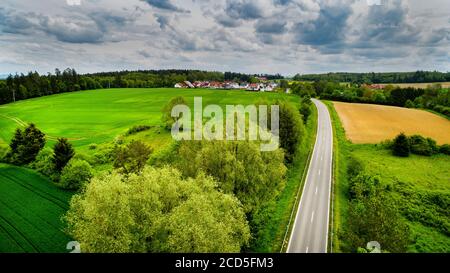 Aerial view of road between fields Stock Photo