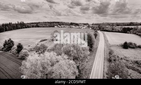 Aerial view of road between fields Stock Photo