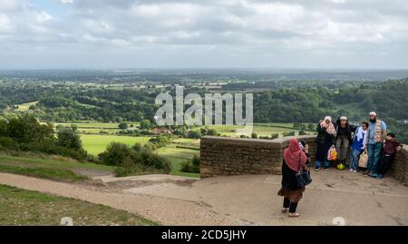 Muslim family taking a photograph at the Box Hill Viewpoint in the Surrey Hills Area of Outstanding Natural Beauty, UK Stock Photo