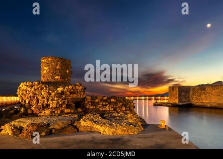 The entrance of the old harbor of Ierapetra, Crete, Greece. To the left ruins of an old lighthouse, to the right, a Venetian castle called 'Kales'. Stock Photo