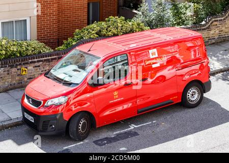 A bright red Vauxhall Royal Mail van out on deliveries, London, UK Stock Photo