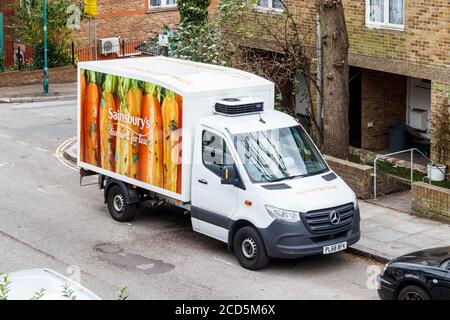 A Sainsbury's supermarket delivery van parked on a residential street in North London, UK Stock Photo