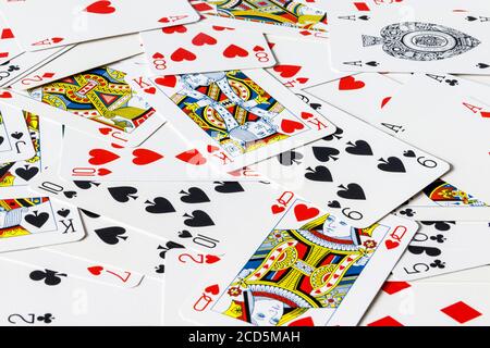 A pack of cards scattered on a table Stock Photo