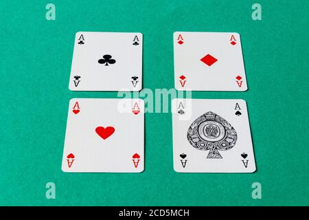 The four aces from a pack of cards set out in a square on a card table Stock Photo