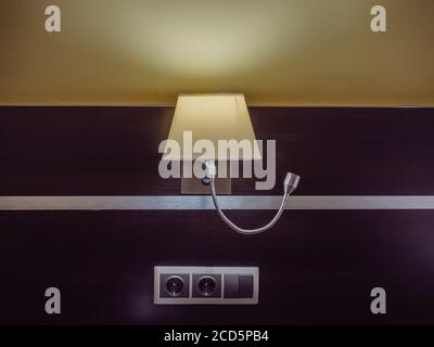 Luminous lamp hanging on the wall with wooden trim Stock Photo