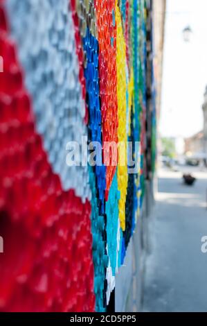 Close-up on plastic bottle caps. Art made of multi colored bottle caps. Stock Photo