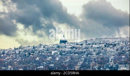 Montreal skyline with first snow falling on Saint Joseph Oratory. Winter view with Mt Royal mount. Quebec Canada city travel North America destination