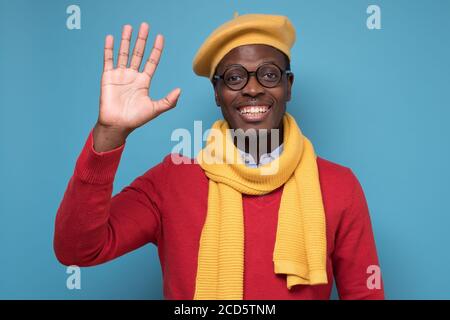 Inspired african man waving hand greeting his friends. Stock Photo