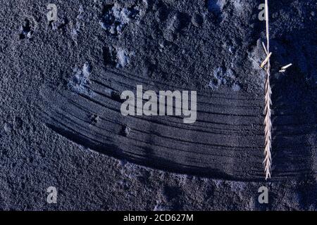 Lines in black sand on beach Stock Photo