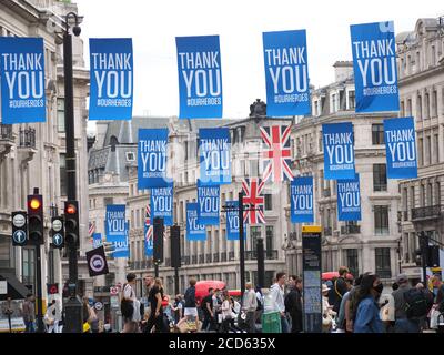 View looking along lines of many flags hanging above Regent Street in London thanking our heroes during the Covid 19 pandemic in 2020