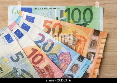 Euro banknotes of different face value fanned out on the table. Paper currency of 5, 10, 20, 50, 100 euro close-up. Wealth, cash savings, wages. Stock Photo