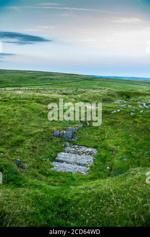 Concrete sleepers covering a deep shaft at Burning Drake lead mine on Eldon Hill, Derbyshire Stock Photo