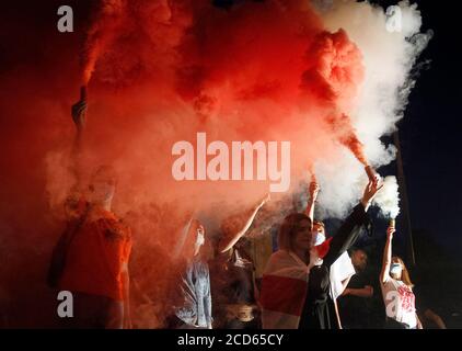 Protesters holding flares during the demonstration.Belarusian citizens who live in Ukraine and Ukrainian activists took part in protest to attract international attention to support the protection of human rights and democracy in Belarus. Protests against rigging the election continue in Belarus following the presidential elections on 9 August. Stock Photo