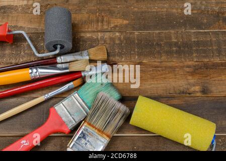 Painting tools various brushes and rollers on wooden table Stock Photo