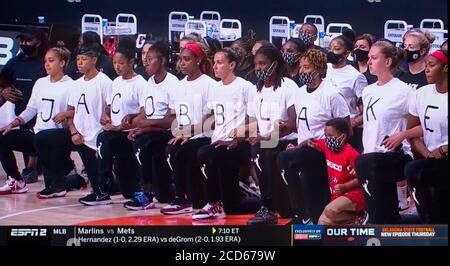 A screen grab from the ESPN2 coverage of the decision made by the six WNBA teams not to play tonight in the wake of the shooting of yet another Black man in America. The Washington Mystics donned t shirts spelling out the name of Jacob Blake, who was shot seven times in the back by a white Kenosha, Wisconsin policeman. Seven holes were cut out of the backs of their shirts, depictions of the seven bullet holes in Mr. 26th Aug, 2020. Blake's back. All of tonight's NBA playoff games were also postponed. Credit: Courtesy Espn2/ZUMA Wire/Alamy Live News Stock Photo