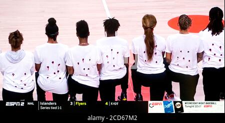 A screen grab from the ESPN2 coverage of the decision made by the six WNBA teams not to play tonight in the wake of the shooting of yet another Black man in America. The Washington Mystics donned t shirts spelling out the name of Jacob Blake, who was shot seven times in the back by a white Kenosha, Wisconsin policeman. Seven holes were cut out of the backs of their shirts, depictions of the seven bullet holes in Mr. 26th Aug, 2020. Blake's back. All of tonight's NBA playoff games were also postponed. Credit: Courtesy Espn2/ZUMA Wire/Alamy Live News Stock Photo