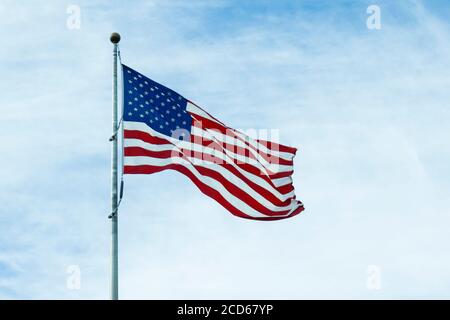 An American flag flaps in the wind generated by the effects of Isaias ...