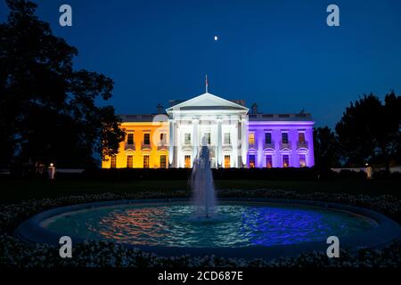 The White House is lit in purple, white, and gold to honor the suffrage movement in Washington, DC, USA 26 August 2020. This year is the 100th anniversary of women's suffrage, which earned women the right to vote.Credit: Jim LoScalzo/Pool via CNP | usage worldwide Stock Photo