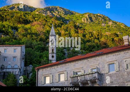 Scenic view of Kapela Sv Ivana Evandeliste or St. Ivan Evangelist Chapel in Perast in Kotor Bay, Montenegro with mountains in the background at sunset Stock Photo