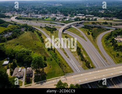 High above highways, interchanges the roads band and the interstate takes you on a fast transportation highway in Cleveland Ohio US drone view Stock Photo