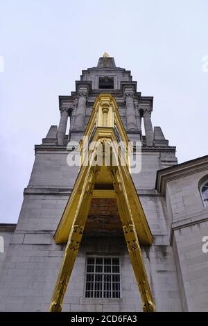 LEEDS, UNITED KINGDOM - Jul 15, 2020: Vertical Image of Leeds Civic Hall underneath a bright golden clock on a clound dull day Stock Photo