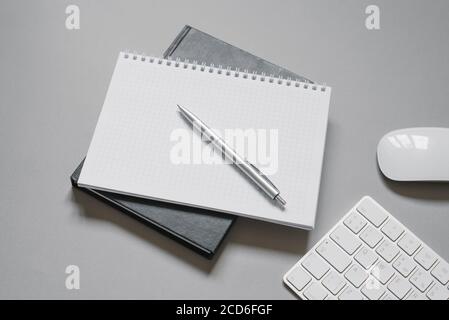 Notebooks or diaries with a blank page and a ballpoint pen on top of them. Office worker's place Stock Photo