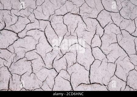 Texture of dry cracked soil after dried puddle Stock Photo