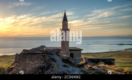 Van, Turkey - September 2013: Sunset over castle of Van and Van lake with a minaret Stock Photo