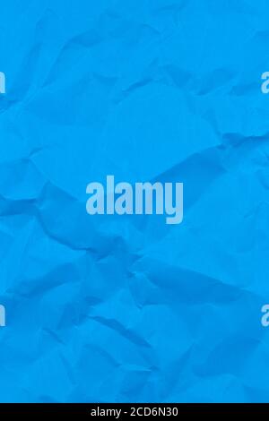 Textured crumpled blue paper background. Vertical Stock Photo
