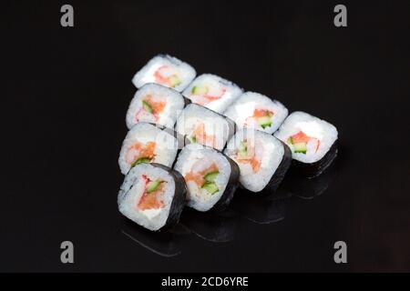 Sushi rolls Futo Maki on a black background. Stock Photo