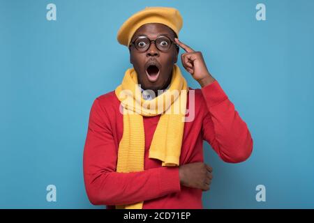 african man screaming in shock, keeping mouth wide open, feeling excited Stock Photo