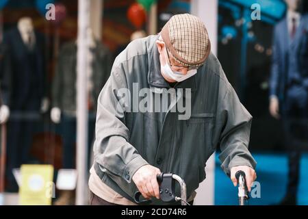 Elderly man in Preston City Centre with Face Mask and walker making his way through town. Stock Photo