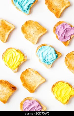 Coloured Toast Pattern of toast bread with colored cheese spread. Layout top view ...