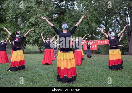 Chinese American dancers from the Wenzhou America New York troupe celebrate their 5th anniversary with a performance in a park in Queens, New York. Stock Photo