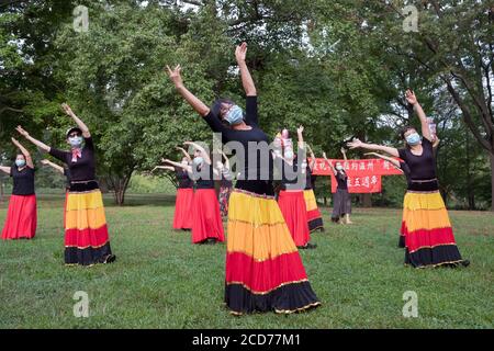 Chinese American dancers from the Wenzhou America New York troupe celebrate their 5th anniversary with a performance in a park in Queens, New York. Stock Photo