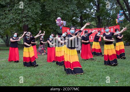 Chinese American dancers from the Wenzhou America New York troupe celebrate their 5th anniversary with a performance in a park in Queens, New York Stock Photo