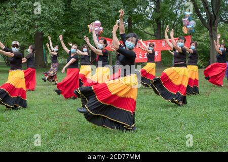 Chinese American dancers from the Wenzhou America New York troupe celebrate their 5th anniversary with a performance in a park in Queens, New York Stock Photo