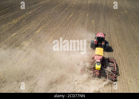 Top view of tractor planting corn seed in field, high angle view drone photography Stock Photo