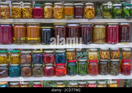 lot of glass jars of different sizes with preservation after harvesting fruits, vegetables, berries, mushrooms. Jam, pickles in jars Stock Photo