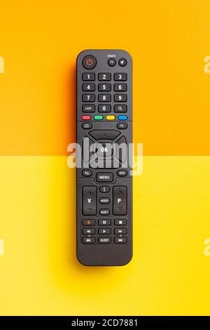 TV remote control on colorful background. Top view. Stock Photo