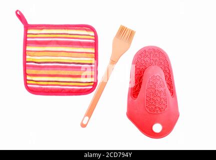 Kitchen accessories potholander and kitchen silicone brush isolated on white background. Stock Photo