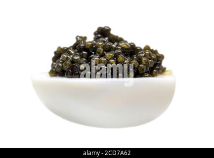 Black caviar on boiled egg isolated on white Stock Photo