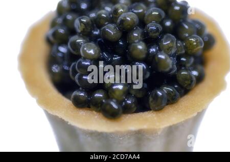 Black caviar in tartlet isolated on white background Stock Photo